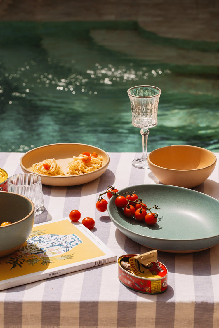 Mora’s Bloom collection: ceramic plates, bowls, and mugs in soft, playful tones inspired by spring. Designed for everyday meals with a calm, joyful feel.