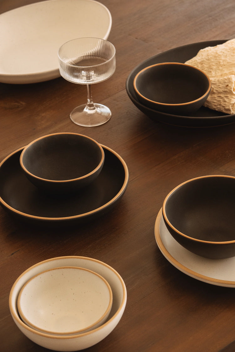 Explore Mora’s monochrome ceramics in oat and liquorice tones. Clean, balanced dinnerware designed for everyday meals, calm tables, and effortless mixing.